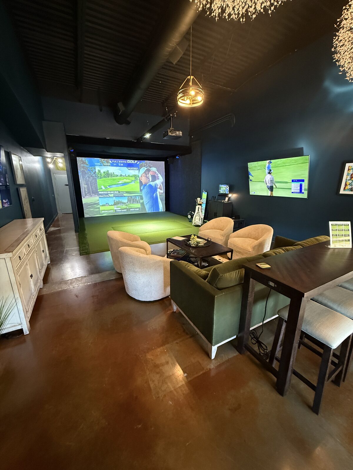Birdie Alley Golf lounge with golf simulator screen and seating